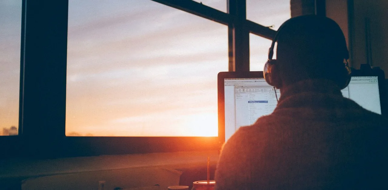 man sitting at computer for webinar